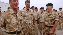 The Duke of Edinburgh shares a joke with the Commanding Officer and soldiers of the Queen's Royal Hussars Battle Group at Basra Air Station in Iraq, October 2006.