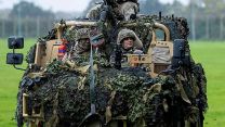 Princess of Wales arrives at a military display stand in the passenger seat of a Jackal Armoured vehicle