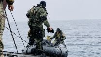 Royal Marine Commandos deploying from a landing craft whilst on NATO's Exercise Cold Response 