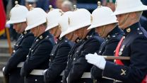 Royal Marines bow their heads as the coffin of Major General Matthew Holmes, the former head of the Royal Marines, is carried into Winchester Cathedral in Hampshire for his funeral