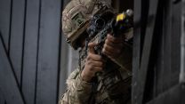 Soldier in a fire position on an urban assault during Exercise Iron Cyclone