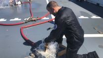 Sailor on board HMS Scott training to deal with fires and floods