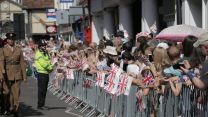 Anonymous hands holding Union flags British flags at Armed Forces Day