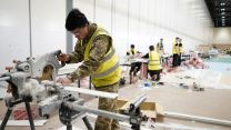 Soldier cuts material at NHS Nightingale 270320 CREDIT NUMBER 10:FLICKR.jpg 