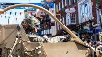 Soldier driving vehicle through Salisbury on Armed forces day 