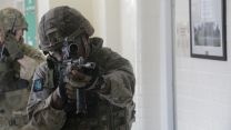 Soldier holds his weapon. 