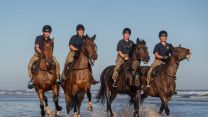 Soldiers and horses from The King's Troop Royal Horse Artillery exercise in the sea at Holkham in Norfolk