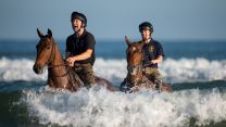 Soldiers and horses from The King's Troop Royal Horse Artillery exercise in the sea at Holkham in Norfolk