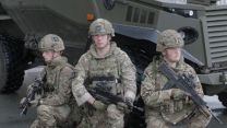 1st Battalion soldiers pose in front of a Foxhound.