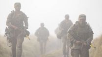 Soldiers from the Royal Military Police patrol through the mist during Exercise Cambian Patrol 111024 CREDIT MOD