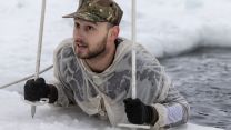 A member of the Force climbing out of the freezing water in Norway (Picture: Royal Navy).