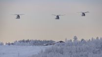 Three helicopters flying over the snow covered ground in Norway (Picture: Royal Navy).