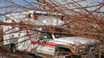The damaged Fire Rescue building in Treasure Cay with the abandoned ambulance.