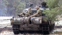 Two Soldiers taking a pause on top of the back of a Challenger 2 main battle tank 24012023 CREDIT MOD Crown Copyright.jpg