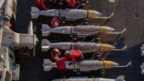 US sailors prepare to stage ordnance onboard the flight deck