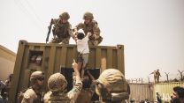 A powerful image of military personnel from UK, Turkey and US assisting a child during evacuation from Kabul airport (Picture: US Department of Defense). UK coalition forces, Turkish coalition forces, and US Marines assist a child during an evacuation at Hamid Karzai International Airport, Kabul, Afghanistan 200821 CREDIT US DEPARTMENT OF DEFENSE.jpg