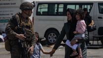 US Marine escorts evacuees at Kabul airport