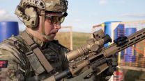 A Royal Marine inspects the controls on the new 5.56mm KS-1 rifle