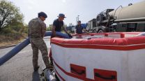 Soldiers from 10 Queen's Own Gurkha Logistic Regiment (10 QOGLR) assisting with filling up water bowsers and Mobile water reservoirs with water from local Welsh farmers and the Wales Fire Service using Military Close Support Tankers (Picture: MOD)