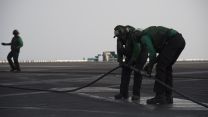 'Green shirts' operate the steam catapult and arrestor wires which trap the aircraft as they land