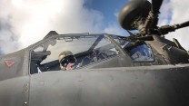 An Army Air Corps Apache pilot looks down at the camera during an exercise on the Barton Stacey Training Area (BSTA) near Winchester. 

Photo Crown Copyright