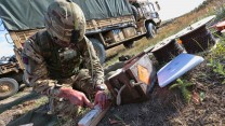 Lance Corporal Longhurst preparing explosives to be laid on a bridge.