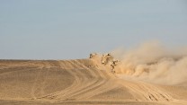 Dust is kicked up from the desert floor from Army Husky and Ridgeback armoured vehicles on 10 May 2014, as part of a 77 vehicle road move following the closure of PB Sterga 2