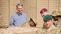 Phillip Hammond MP, Secretary of State for Defence, shares a joke with soldiers of 4 SCOTS Bn who have lived within PB Sterga 2 for over six months