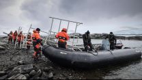 HMS Protector crew members transporting equipment from their boats (Picture: Royal Navy).