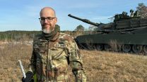 Jay Tension holding an aft cap in front of the tank he shot at Fort Moore in Georgia on 4 December (Picture: Courtesy Picture). 