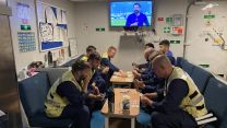 Navy personnel spend some of their free time playing cards.