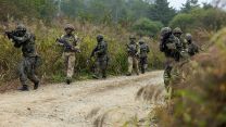 Soldiers from C Company, the 1st Battalion Scots Guards and the Republic of Korean Army Patrolling along a dirt track during the defensive phase of Exercise IMJIN WARRIOR (Picture: MOD).