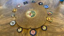 HMS Queen Elizabeth Rose Table in the Captain's Day Cabin displaying patches collected on the deployment.
