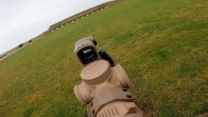 For close-quarters work, operators can switch to the red dot sight above the scope