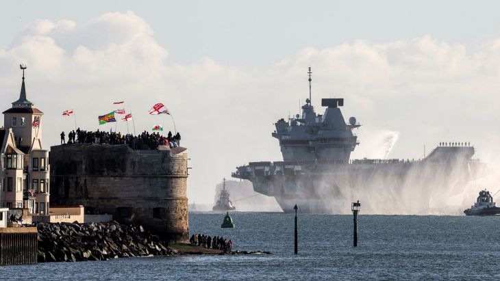 Crowds wave from the Round Tower as HMS Prince of Wales sails towards Portsmouth Naval Base