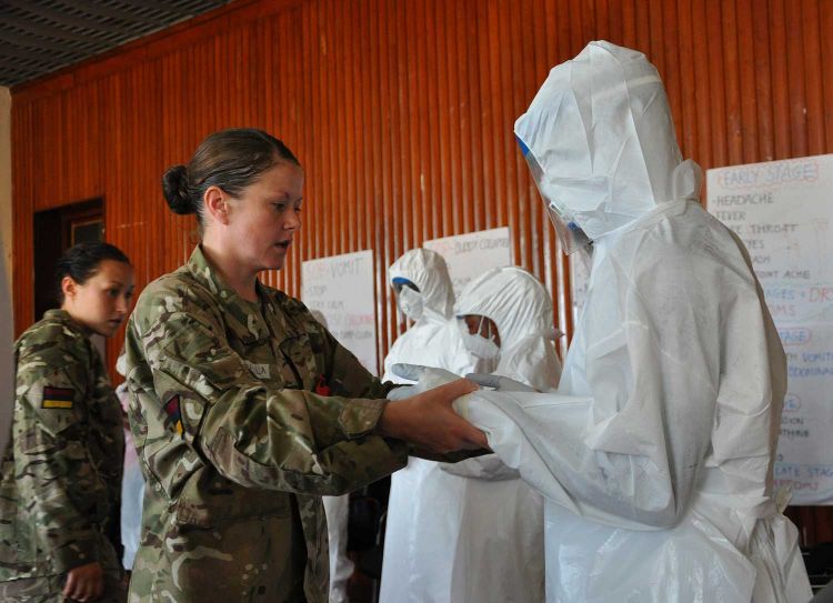 Medics teaching the correct procedure for wearing personal protective equipment