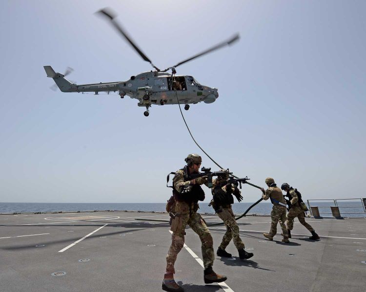 Royal Marines carry out fast roping training from HMS Duncan's Lynx helicopter