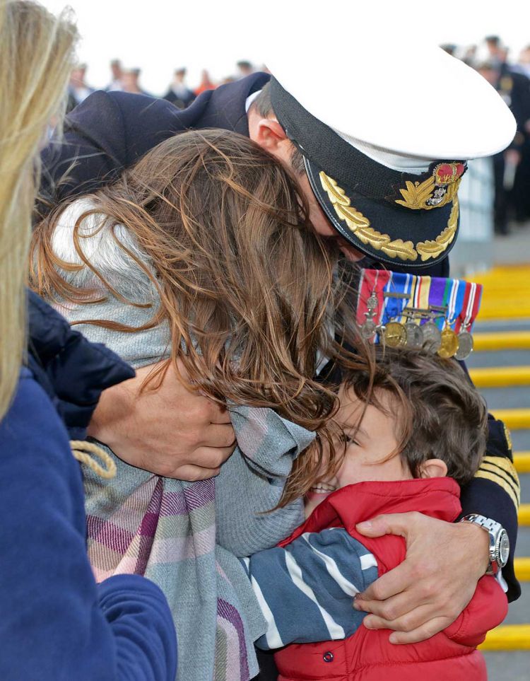 Commander Peter Laughton reunited with his family