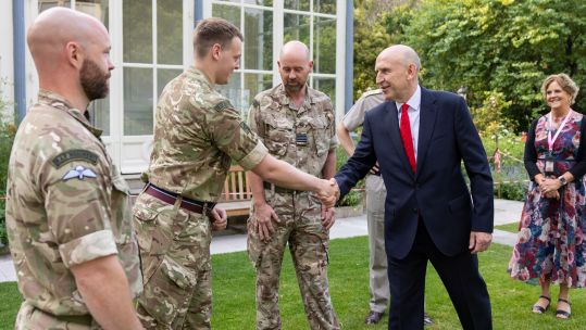 John Healey shakes hands with RAF personnel who are providing assistance to the French security services