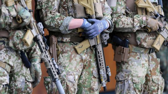 Special Forces soldiers armed with Heckler Koch G95K rifles show off their Multitarn pattern uniforms