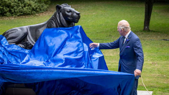 The King unveils the bronze lion statue marking 20 years of The Royal Regiment of Scotland in Princes Street Garden