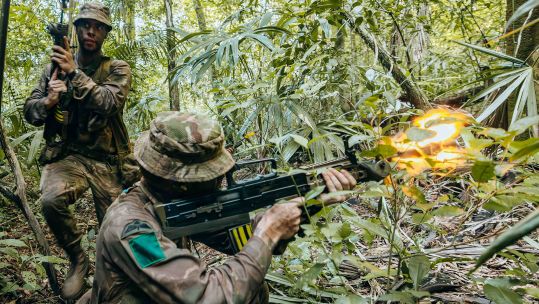 A para opens fire with blank ammo from his SA80 L85 A2, but operating in the jungle is about surviving just as much as engaging the enemy
