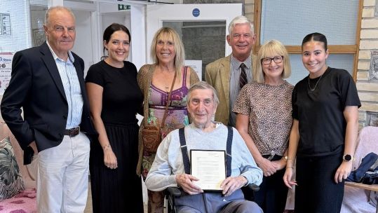 With Fred Bickham are Giles Ebbutt (right), Chair of the Yealm branch of the Royal British Legion in Devon, Tim Harbinson (left) and his family (Picture: Royal Navy)