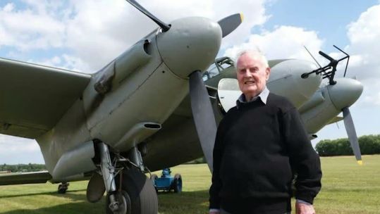 Colin Bell pictured with a de Havilland Mosquito - Colin flew the bomber variant in raids over Germany