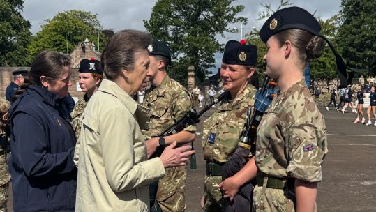Princess Anne meets with a performer of the Royal Edinburgh Military Tattoo at a rehearsal at Redford Barracks