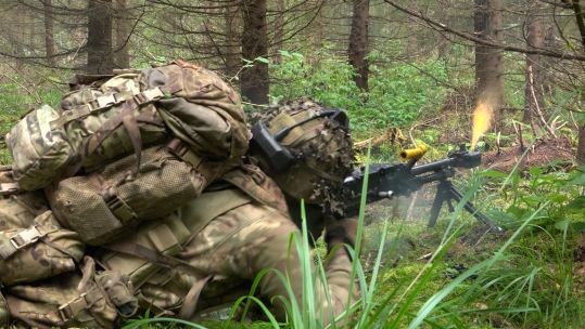 A soldier from 3 Scots fires a General Purpose Machine Gun during Exercise Forest Guardian