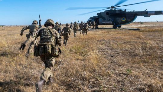 Troops from 16 Air Assault Brigade embark on a Ukrainian Mil Mi-8 assault helicopter
