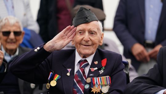 100-year-old D-Day veteran Bernard Morgan salutes on board the Brittany Ferries ship from Portsmouth to Caen