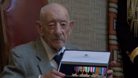 100-year-old Second World War veteran John Jude with seven new medals which were presented to him, at a VJ Day ceremony, after his were lost