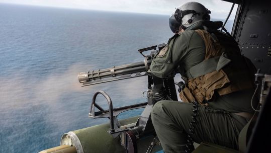 A US Marine Corps gunner fires an M134 minigun from a UH-1Y Venom helicopter, a role first carried out in Vietnam